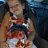 Khloe joined the competition — help win amazing prizes! child, toddler, car_seat, curly_hair, plush_toy, doll, seatbelt, smile, indoor, car_interior, clothing, person, sitting, toy, happy, hair_tie, window, seat, skin, hand