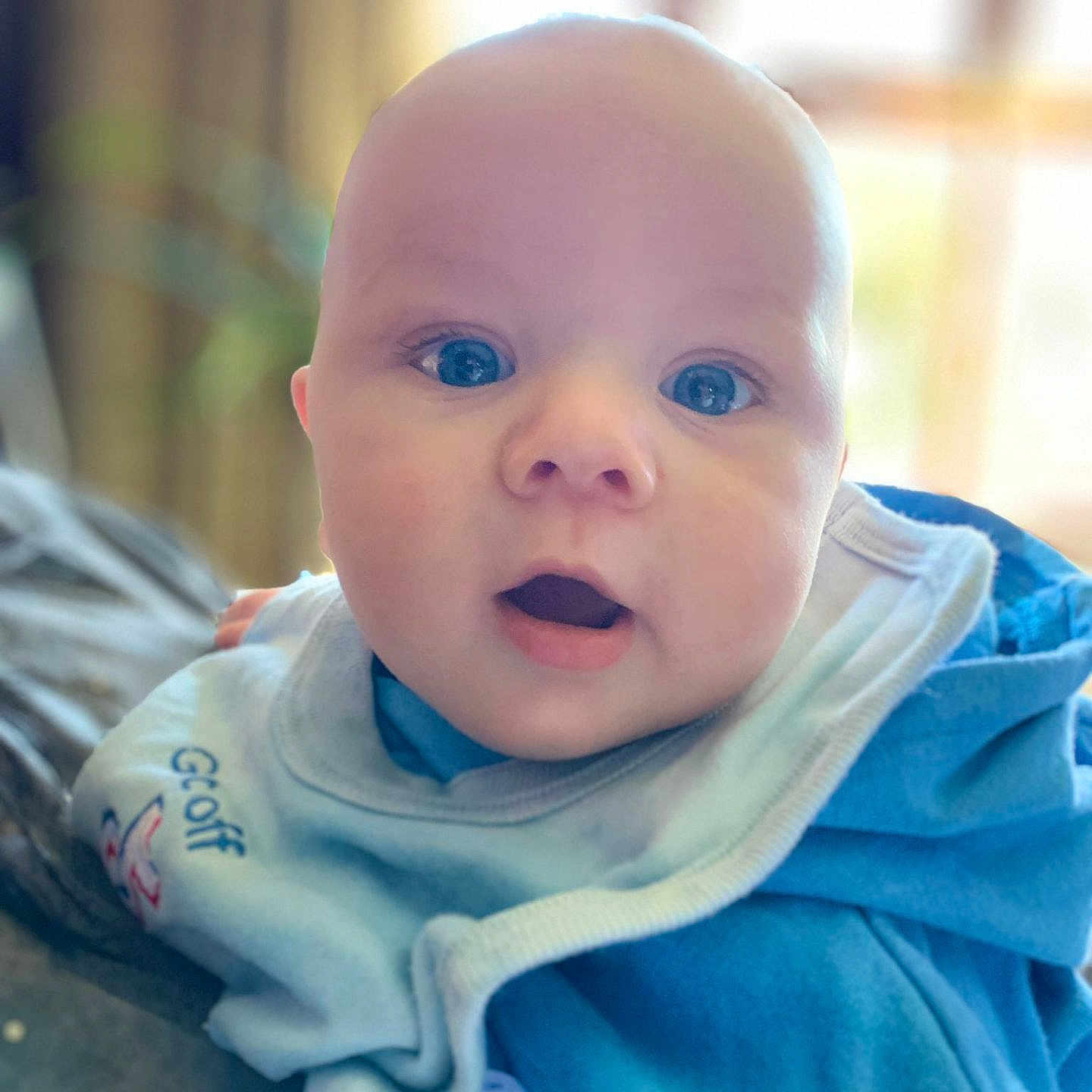 Cole joined the competition — help win amazing prizes! baby, bodypart, clothing, coat, face, happy, head, hood, hoodie, jacket, knitwear, newborn, pants, person, photography, portrait, sitting, smile, sweater, sweatshirt