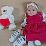 Alicia participe au concours pour gagner de l'argent avec cette photo : baby, infant, smiling, headband, dress, teddy_bear, plush, red_heart, baby_shoes, sitting, portrait, indoor, blanket, cute, pink_dress, button, white_shoes, accessory, one_person, soft_toy