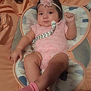 Briella joined the competition — help win amazing prizes! baby, infant, pink_clothing, headband, baby_seat, cushion, socks, cute, indoor, child, portrait, relaxing, baby_accessory, smile, fist, small_child, comfortable, closeup, person, resting