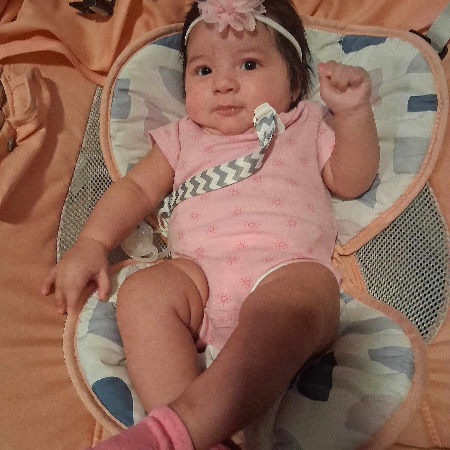 Briella joined the competition — help win amazing prizes! baby, infant, pink_clothing, headband, baby_seat, cushion, socks, cute, indoor, child, portrait, relaxing, baby_accessory, smile, fist, small_child, comfortable, closeup, person, resting