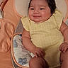 baby, smile, yellow_clothing, infant, cushion, baby_seat, chubby_cheeks, happy, indoors, cute, child, skin, face, hand, leg, resting, relaxed, seat, portrait, young
