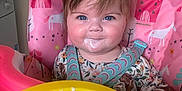 Isabelle is registered to the contest to win money with this photo: baby, bowl, chair, cream, cushion, cutlery, dessert, face, food, furniture, happy, head, homedecor, icing, meal, person, photography, portrait, smile, spoon