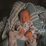 Cody joined the competition — help win amazing prizes! baby, sleeping, blanket, onesie, cozy, infant, child, cute, peaceful, soft, striped_blanket, animal_print, indoors, resting, comfortable, portrait, newborn, warm, hands, face