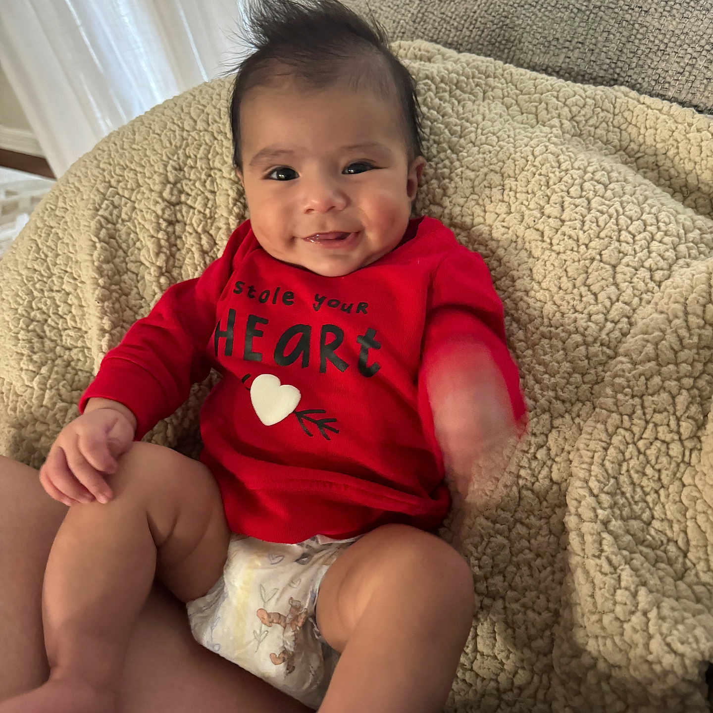 Eliam is registered to the contest to win money with this photo: baby, bodypart, clothing, couch, cushion, diaper, face, finger, furniture, hand, happy, head, homedecor, person, photography, portrait, shorts, sitting, smile, t_shirt