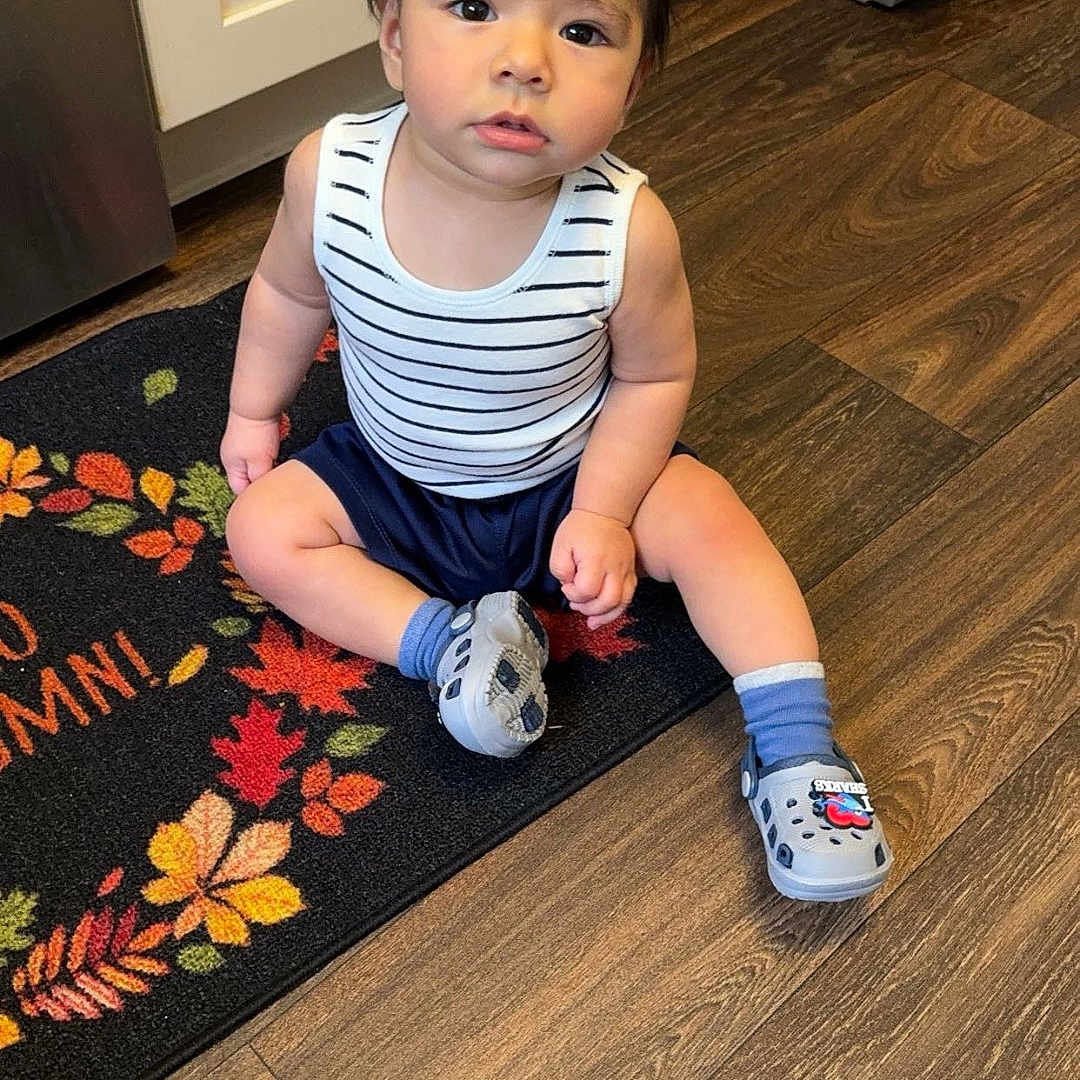 Eliam joined the competition — help win amazing prizes! baby, clothing, crawling, door, face, footwear, hardwood, head, indoors, interiordesign, mat, pants, person, photography, portrait, shoe, shorts, sitting, stainedwood, wood