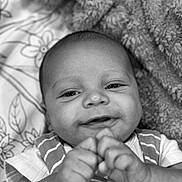 Levi joined the competition — help win amazing prizes! baby, infant, smiling, face, hands, blanket, clothing, striped, cute, portrait, closeup, happy, skin, child, newborn, laying, indoors, soft, black_and_white, expression