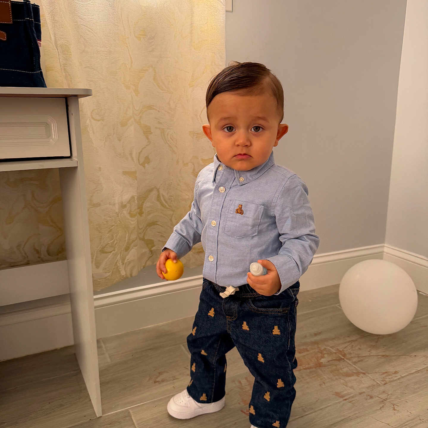 Kyliam is registered to the contest to win money with this photo: balloon, boy, button_down_shirt, child, curtain, denim_jeans, expression, flooring, furniture, hand, indoor, pocket, portrait, short_hair, sneakers, standing, toddler, toy, toy_ball, white_shoes