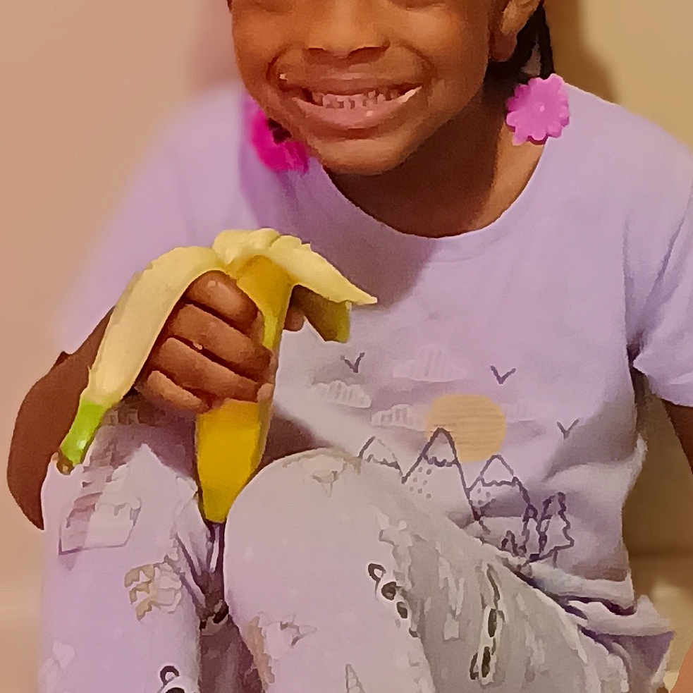 Ashanti joined the competition — help win amazing prizes! banana, bodypart, child, clothing, face, female, finger, food, fruit, girl, hand, happy, head, person, photography, plant, portrait, produce, smile, tape