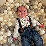 baby, child, smiling, denim, suspenders, white_balls, gray_balls, soft_surface, holiday, christmas, cute, infant, clothing, portrait, happy, lying_down, indoor, festive, casual, person