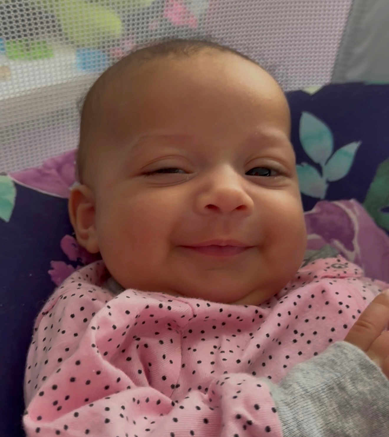 Olivia joined the competition — help win amazing prizes! baby, infant, smile, face, blanket, polka_dot, clothing, cushion, head, cheek, skin, person, indoors, closeup, portrait, happy, cute, newborn, expression, resting