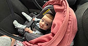 Mia joined the competition — help win amazing prizes! baby, car_seat, infant, child, blanket, car_interior, seatbelt, clothing, cute, person, transportation, safety, young_child, indoor, car, looking_up, pink_blanket, head, eyes, hands