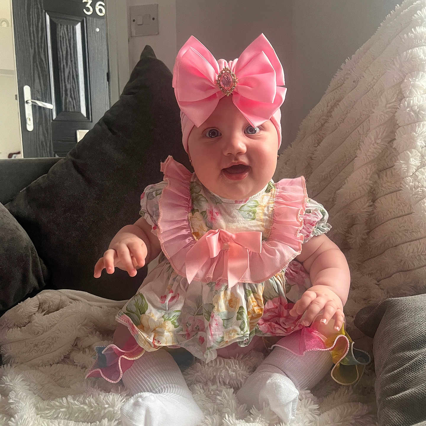Renlea-Rae is registered to the contest to win money with this photo: accessories, baby, bonnet, clothing, costume, couch, cushion, dress, face, formalwear, furniture, hat, head, homedecor, hosiery, person, photography, portrait, sitting, sock