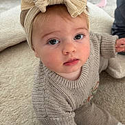 Raya is registered to the contest to win money with this photo: baby, bow, carpet, child, cozy, crawling, curious, cute, expression, floor, hand, headband, indoor, infant, knitted_clothing, looking_up, person, soft_texture, sweater, young_child