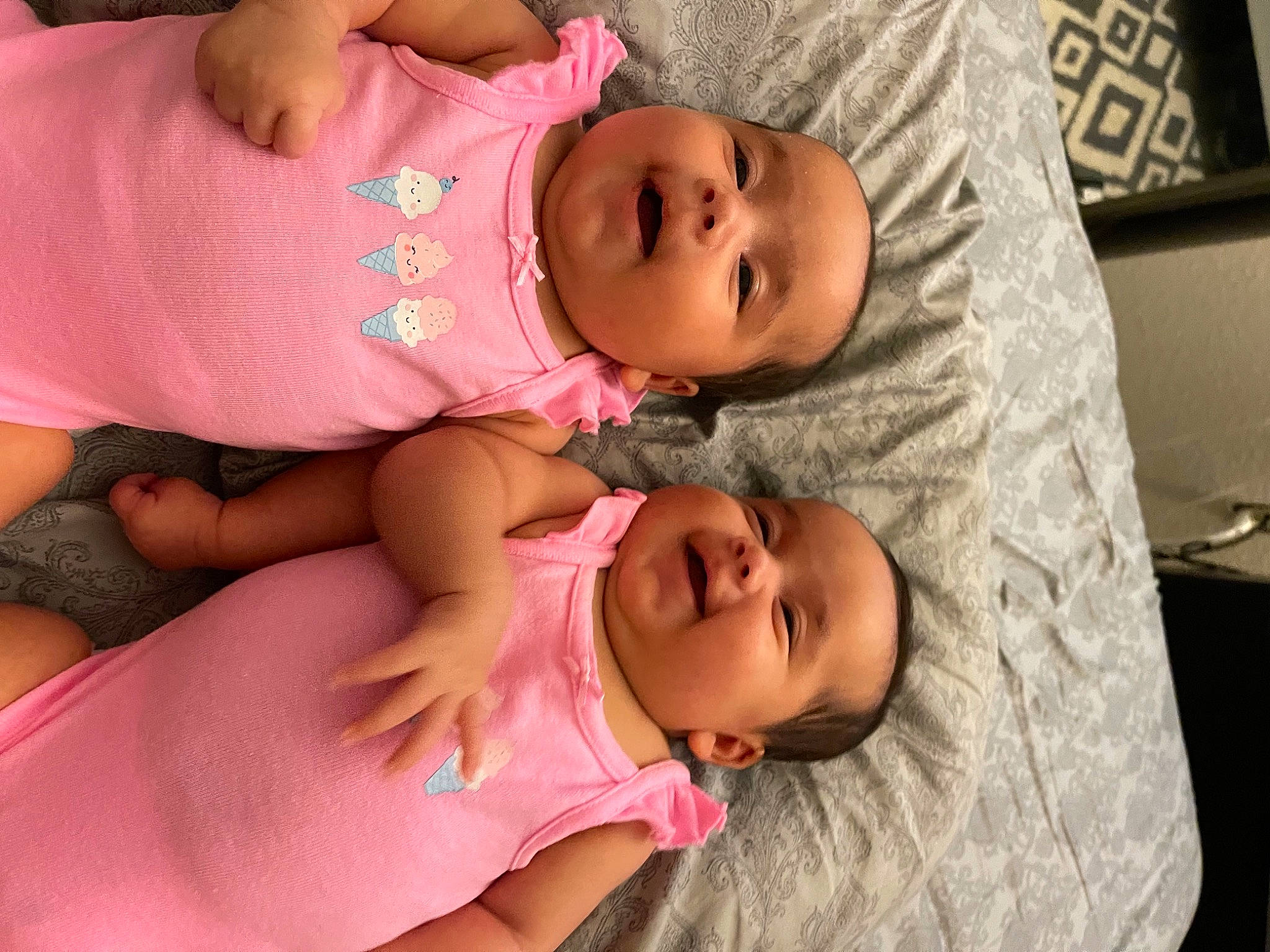 Twins is registered to the contest to win money with this photo: baby, baby_toddler_clothing, cheek, clothing, comfort, eye, eyebrow, face, finger, happy, headgear, headwear, iris, lip, mouth, nose, organ, person, pink, skin