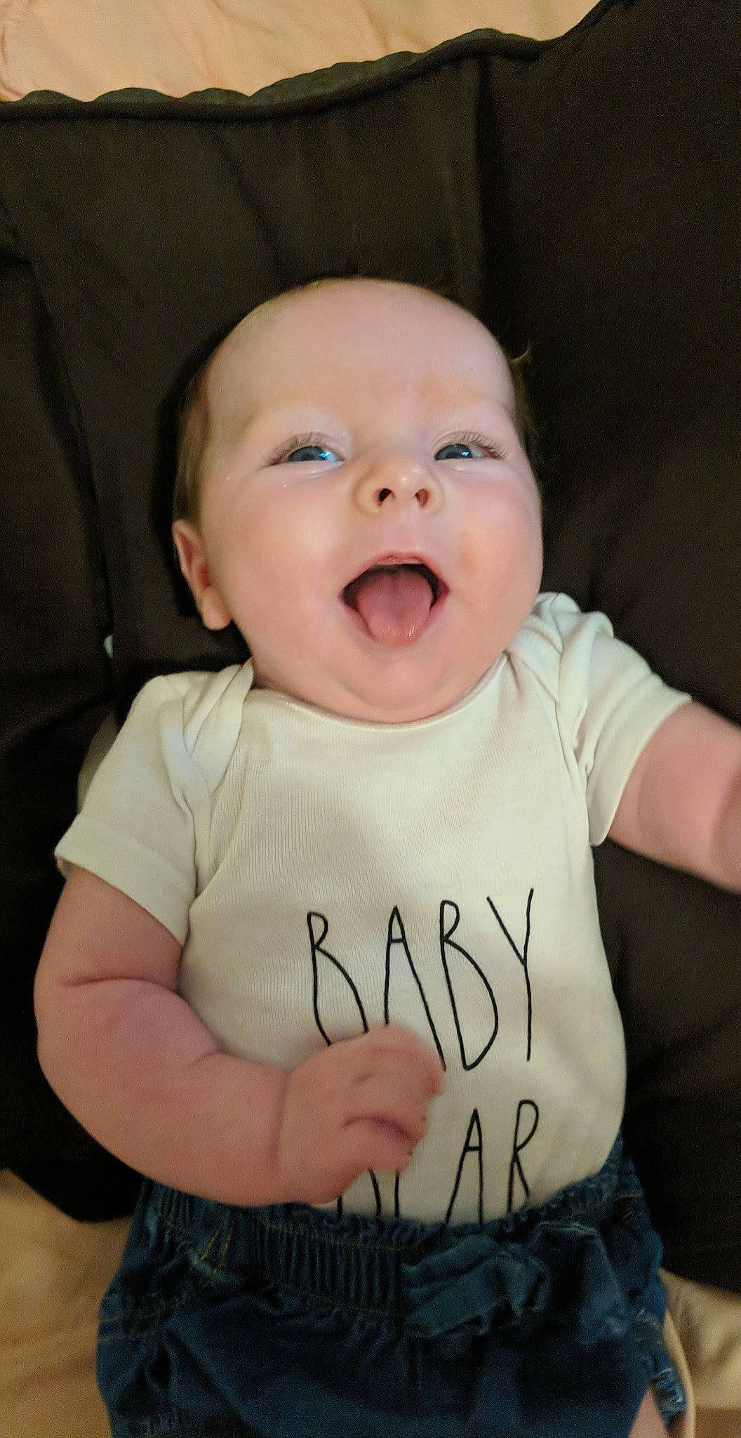 Delilah is registered to the contest to win money with this photo: baby, baby_toddler_clothing, cheek, comfort, eyebrow, finger, flash_photography, gesture, happy, iris, lip, mouth, neck, nose, organ, person, skin, sleeve, smile, t_shirt