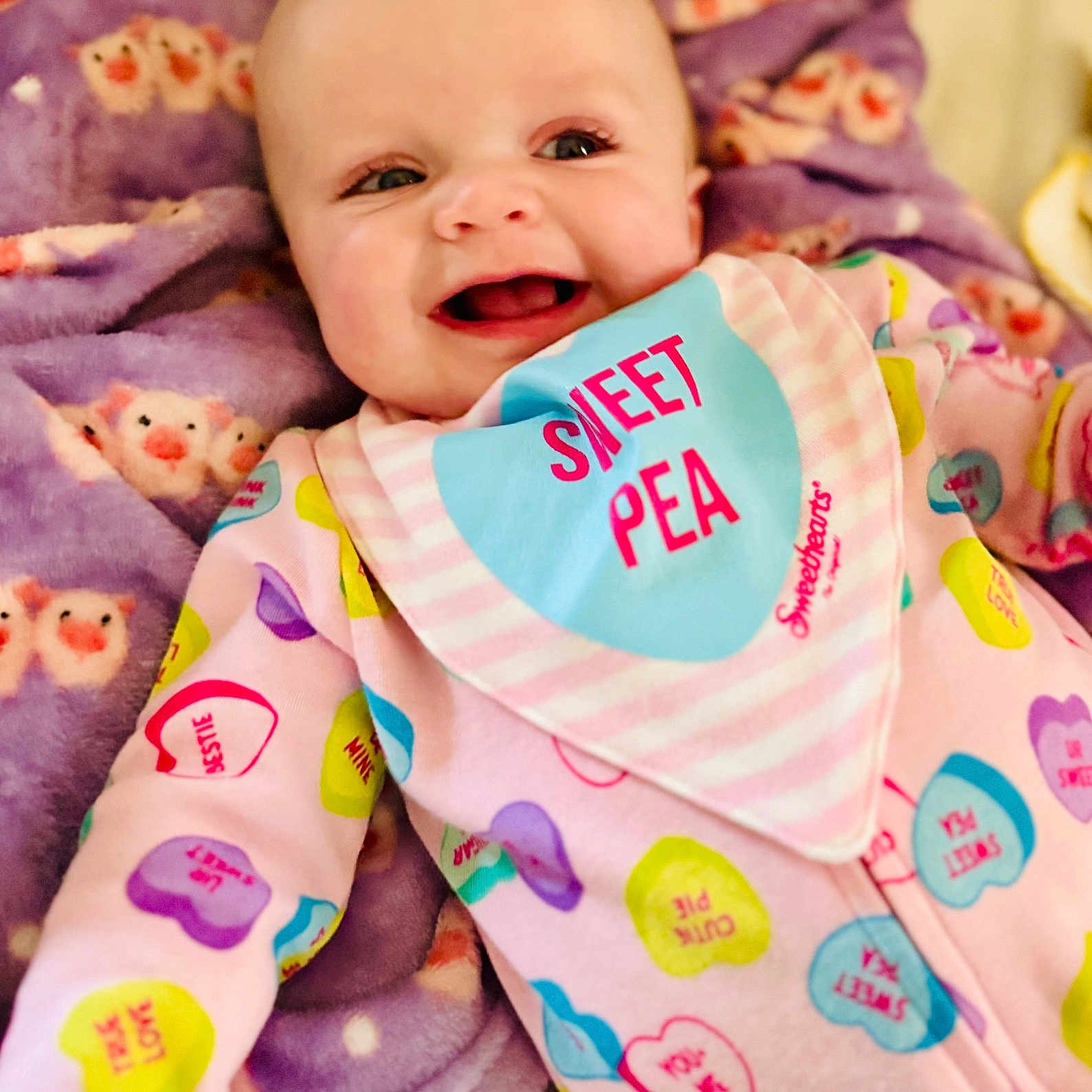 Saylor joined the competition — help win amazing prizes! baby, babylaughing, bib, blanket, clothing, face, happy, head, laughing, newborn, pajamas, person, photography, portrait, quilt, smile