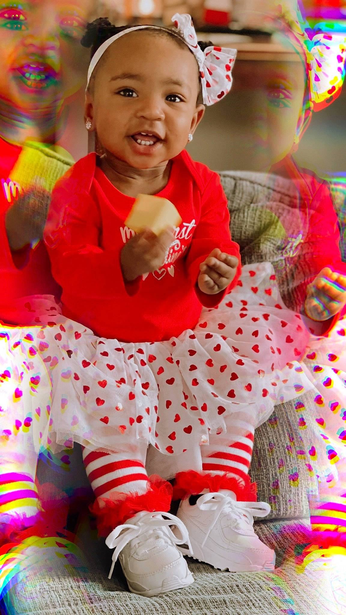 Loyalty is registered to the contest to win money with this photo: baby_toddler_clothing, beauty, child, event, face, facial_expression, fun, green, happy, human_body, leisure, pattern, people, person, pink, red, sitting, skin, smile, toddler