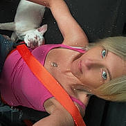 Sophia Michelle Mae joined the competition — help win amazing prizes! woman, dog, seatbelt, pink_top, blonde_hair, sleeping_dog, white_dog, selfie, car_seat, watch, arm, necklace, relaxed, casual, indoor, portrait, closeup, animal, pet, resting
