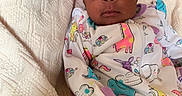 Kemyra joined the competition — help win amazing prizes! baby, infant, child, portrait, wide_eyes, pink_bow, headband, onesie, animal_print, unicorn_pattern, giraffe_pattern, blanket, bed, indoors, reclining, sitting, face, cute, fashion, cozy