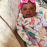 baby, infant, child, portrait, wide_eyes, pink_bow, headband, onesie, animal_print, unicorn_pattern, giraffe_pattern, blanket, bed, indoors, reclining, sitting, face, cute, fashion, cozy