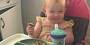 Ember joined the competition — help win amazing prizes! toddler, high_chair, snack, sippy_cup, kitchen, smile, child, face, eating, furniture, floor, foot, clothing, person, plastic_plate, baby, indoor, expression, seat, table