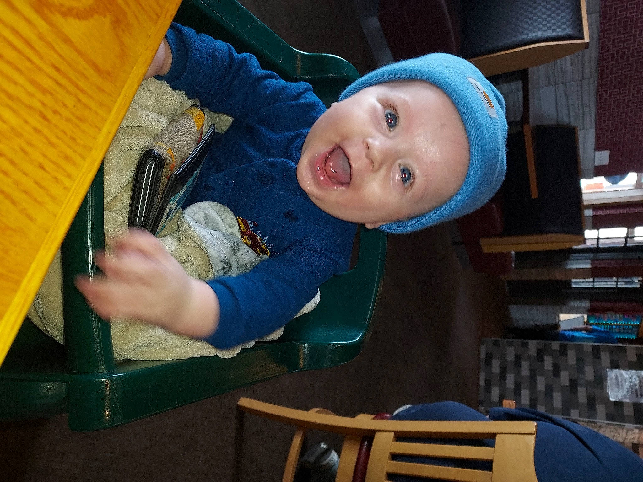 Westyn is registered to the contest to win money with this photo: baby, baby_products, baby_toddler_clothing, chair, child, comfort, electric_blue, fun, happy, hat, headwear, leisure, person, recreation, room, sitting, smile, sun_hat, thumb, toddler