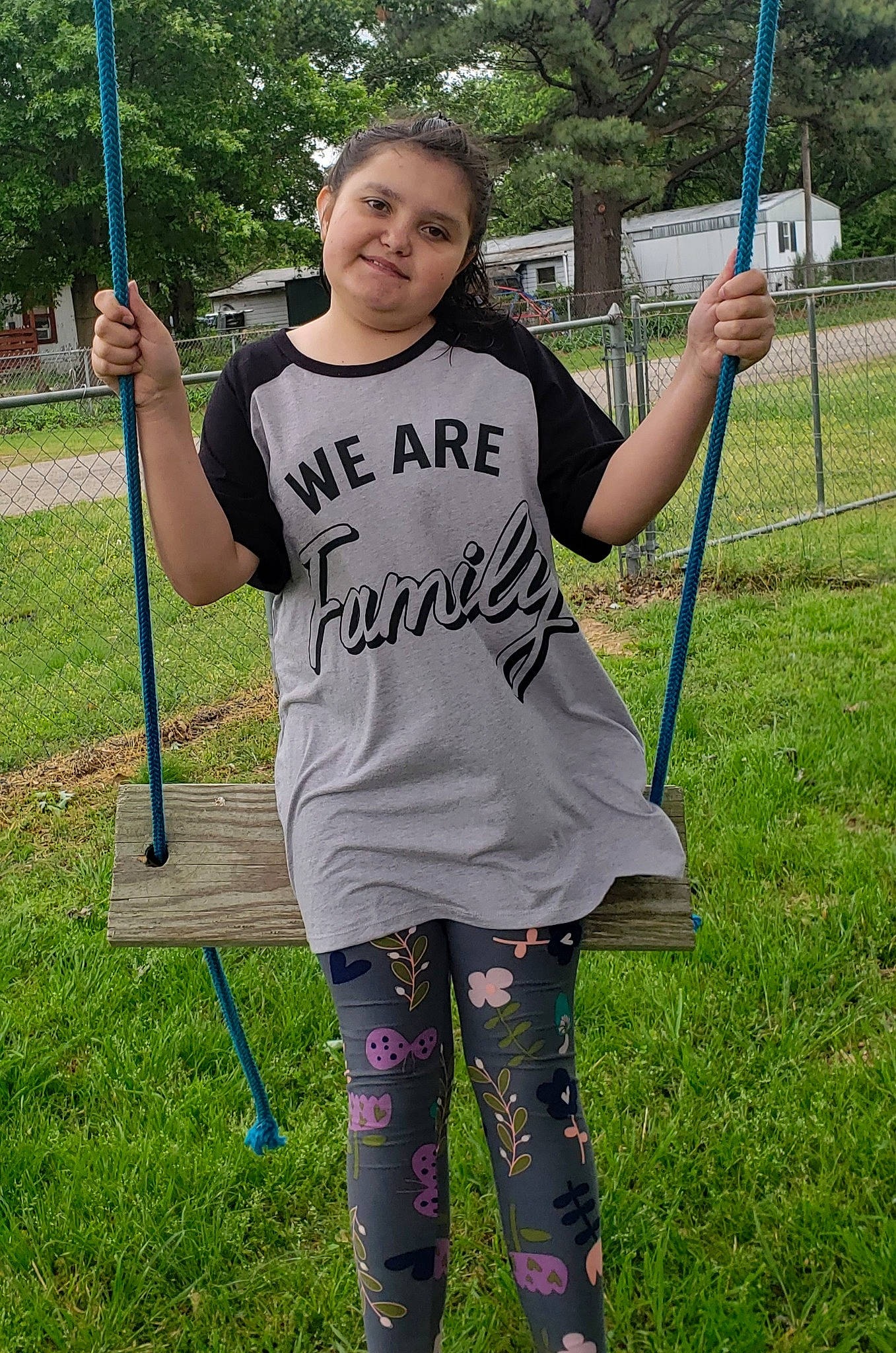 Kendra-rose is registered to the contest to win money with this photo: child, fun, grass, grassland, happy, joy, leisure, outdoor_play_equipment, person, plant, play, playground, pole, recreation, shoulder, sleeve, smile, soil, spring, swing