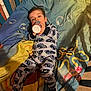 toddler, child, pajamas, bottle, blanket, bed, face, person, indoor, sleepwear, cute, resting, comfort, colorful, pattern, lying_down, young_child, nursery, cozy, drink