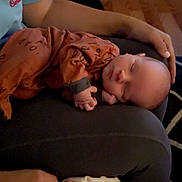 Nolan Knox is registered to the contest to win money with this photo: baby, sleeping, pajamas, hand, lap, person, indoor, cozy, peaceful, child, infant, relaxing, clothing, floor, carpet, blanket, wooden_floor, rest, comfort, toddler