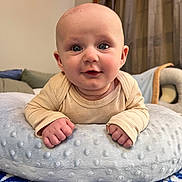 Lincoln joined the competition — help win amazing prizes! baby, infant, pillow, blanket, indoors, face, hands, smile, curious, blue, pattern, cozy, cute, child, toddler, soft, clothing, portrait, closeup, home