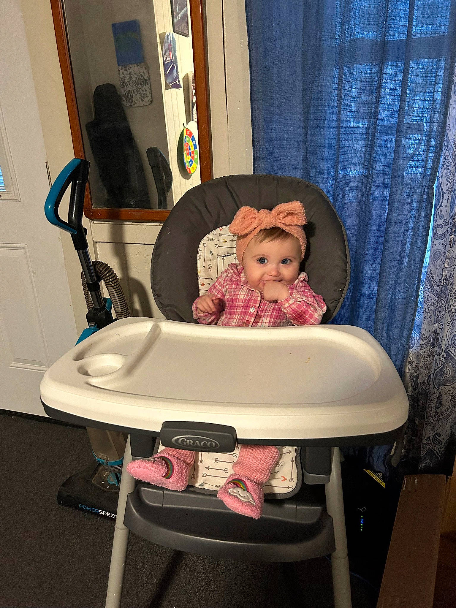 Sabrina is registered to the contest to win money with this photo: baby, baby_products, baby_toddler_clothing, chair, comfort, curtain, event, flooring, hardwood, interior_design, leisure, magenta, oval, person, picture_frame, room, sitting, table, toddler, windsor_chair