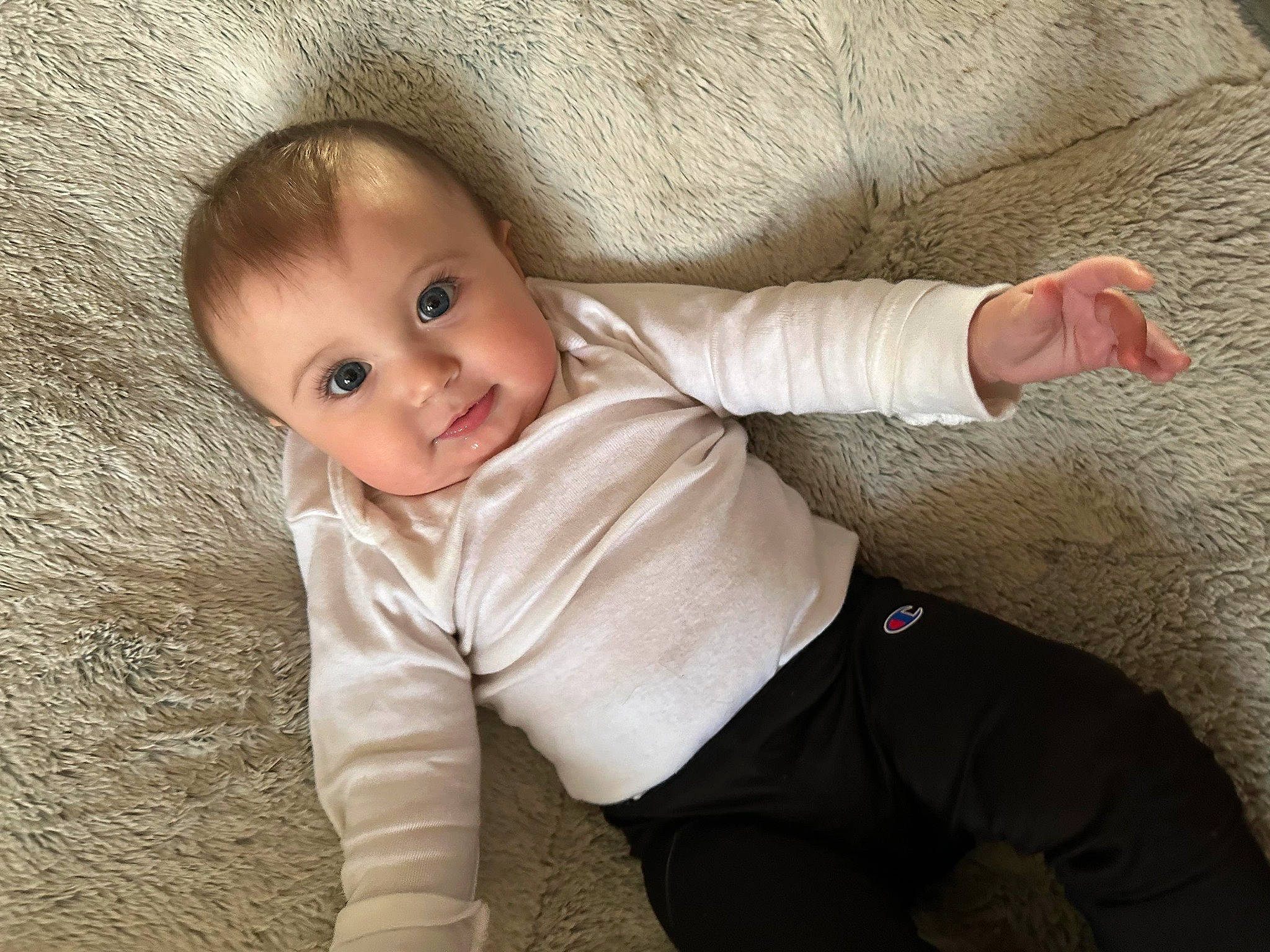 Sabrina is registered to the contest to win money with this photo: baby, baby_toddler_clothing, cheek, chin, comfort, eye, facial_expression, finger, floor, flooring, gesture, head, nose, person, skin, sleeve, smile, textile, toddler, vertebrate
