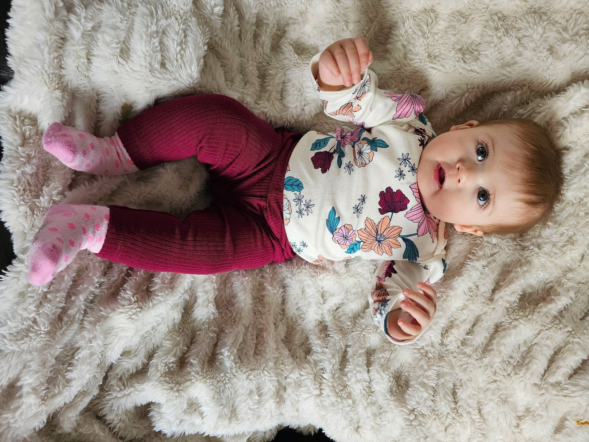 Hannah is registered to the contest to win money with this photo: arm, baby, baby_toddler_clothing, child, comfort, eye, face, head, headgear, human_body, linens, pattern, person, pink, skin, sleeve, sock, textile, thigh, toddler