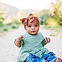 baby, child, infant, headwrap, bow, green_dress, denim, jeans, barefoot, sitting, outdoor, gravel_path, portrait, bokeh, nature, trees, cute, big_eyes, expression, photography