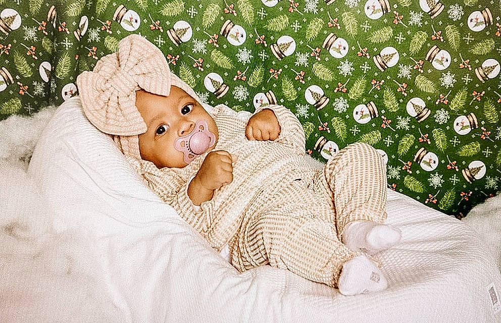 Jennah a rejoint le concours — aidez-le/la à gagner de superbes lots ! baby, comfort, costume_hat, doll, dress, event, fashion_accessory, grass, happy, hat, head, headwear, holiday, human_body, linens, ornament, pattern, people_in_nature, person, plant