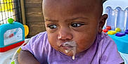 Kahlani is registered to the contest to win money with this photo: baby, child, colorful_cushion, curious, door, drool, expression, face, furniture, gaze, hand, indoor, infant, milk, purple_shirt, skin, toy, walker, window, young