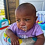 baby, child, colorful_cushion, curious, door, drool, expression, face, furniture, gaze, hand, indoor, infant, milk, purple_shirt, skin, toy, walker, window, young
