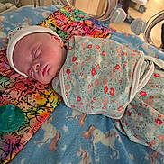 Addalyn is registered to the contest to win money with this photo: newborn, baby, swaddle, sleeping, blanket, unicorn, hospital, incubator, pacifier, floral, pattern, colorful, pillow, infant, cute, peaceful, resting, child, medical, bed