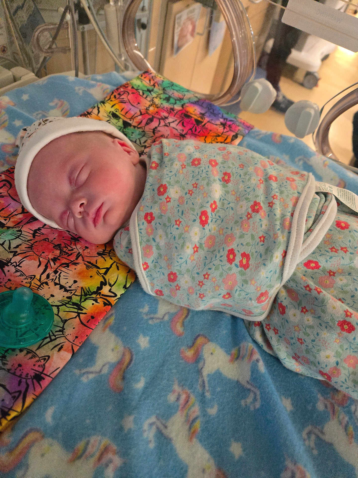 Addalyn is registered to the contest to win money with this photo: newborn, baby, swaddle, sleeping, blanket, unicorn, hospital, incubator, pacifier, floral, pattern, colorful, pillow, infant, cute, peaceful, resting, child, medical, bed