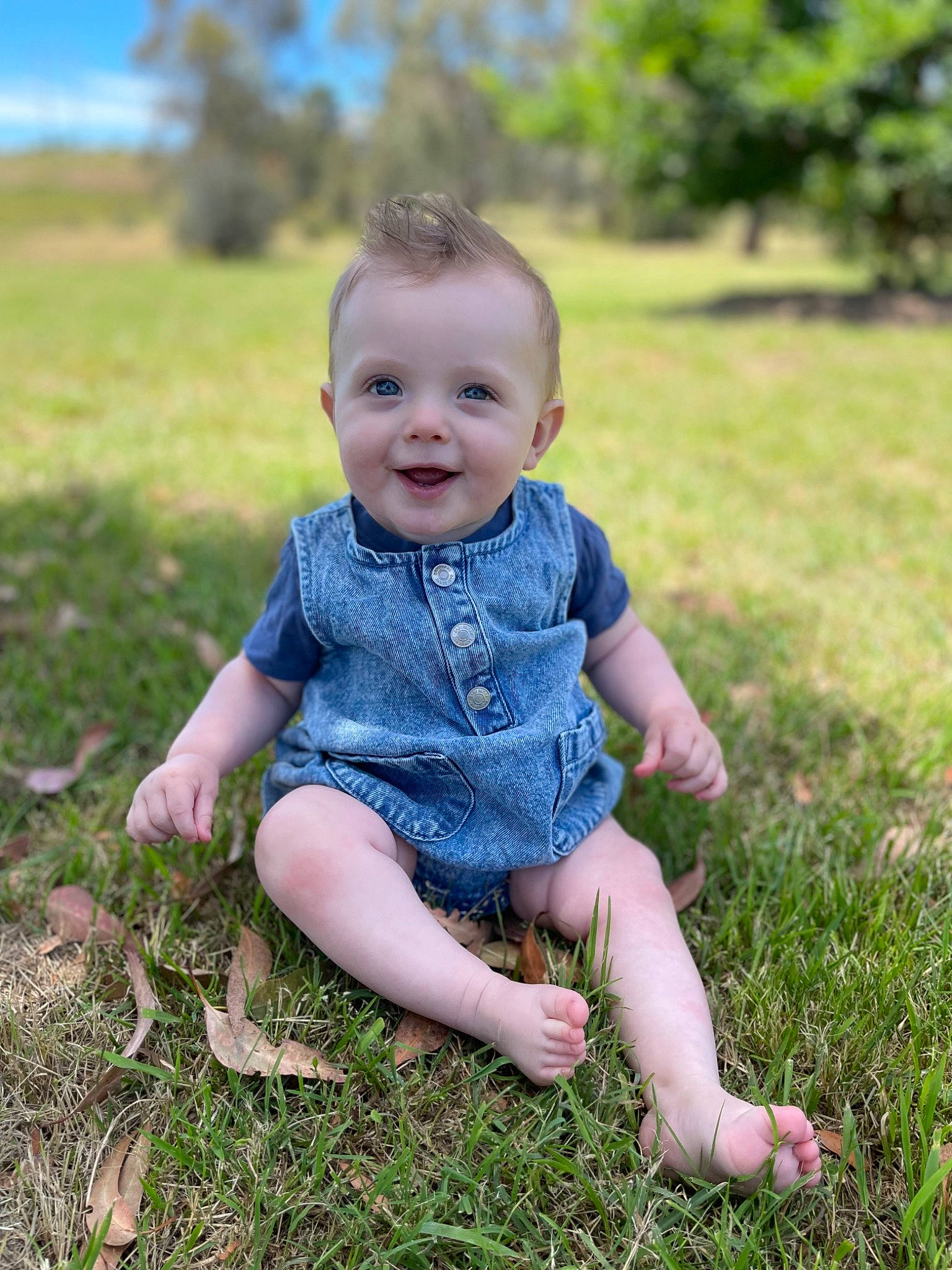 Benji is registered to the contest to win money with this photo: baby, baby_toddler_clothing, child, flash_photography, foot, fun, grass, grass_family, grassland, happy, joy, people_in_nature, person, plant, sandal, sitting, skin, smile, sunlight, toddler