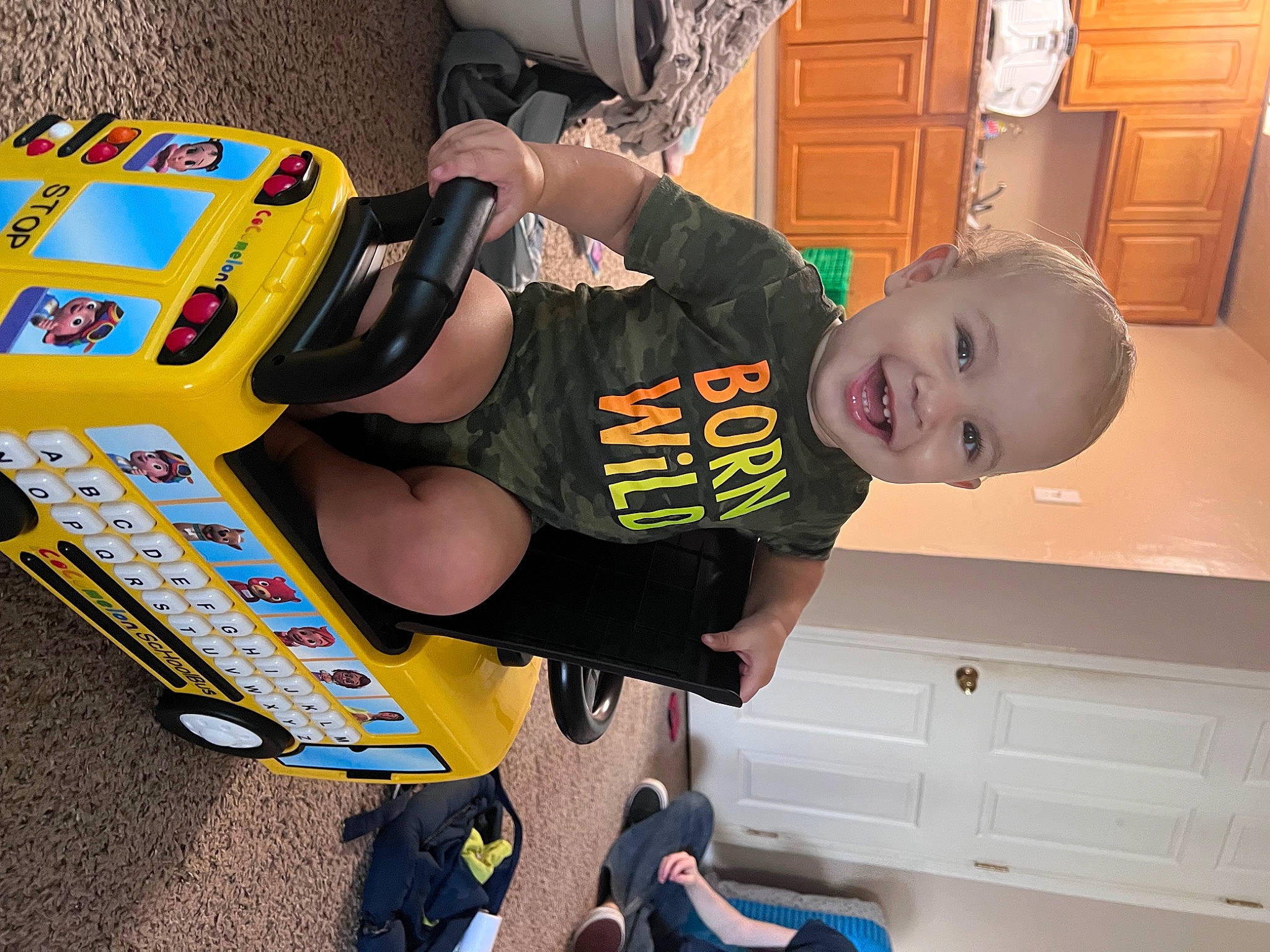 Marcel is registered to the contest to win money with this photo: auto_part, automotive_design, automotive_exterior, automotive_tire, automotive_wheel_system, baby, baby_toddler_clothing, bumper, child, fun, joy, motor_vehicle, person, personal_protective_equipment, plant, play, smile, t_shirt, tire, toddler
