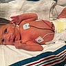 Evelyn is registered to the contest to win money with this photo: newborn, baby, infant, hospital, bassinet, medical_monitoring, electrodes, wires, diaper, blanket, portrait, lying_down, awake, wide_eyed, face, hair, skin, premature_baby, healthcare, indoors