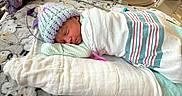 Evelyn is registered to the contest to win money with this photo: newborn, baby, sleeping, infant, hospital, swaddled, blanket, hat, crocheted_hat, pacifier, face, portrait, cozy, resting, bed, pastel, striped_blanket, indoors, peaceful, nursery