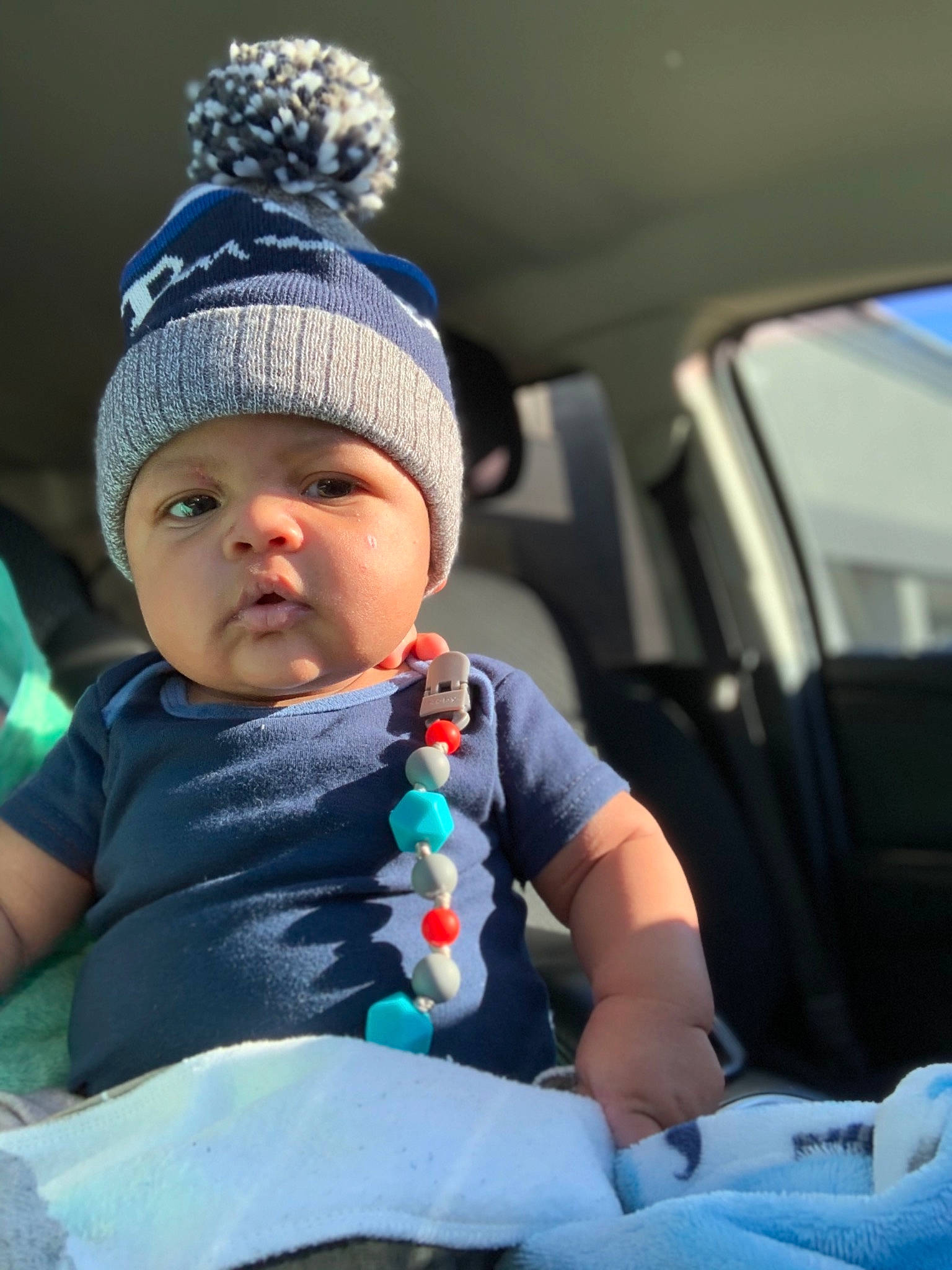 Kendrick joined the competition — help win amazing prizes! automotive_exterior, baby, baby_toddler_clothing, cap, car, car_seat, car_seat_cover, child, cool, fun, happy, hat, head_restraint, headwear, knit_cap, motor_vehicle, person, sitting, t_shirt, toddler