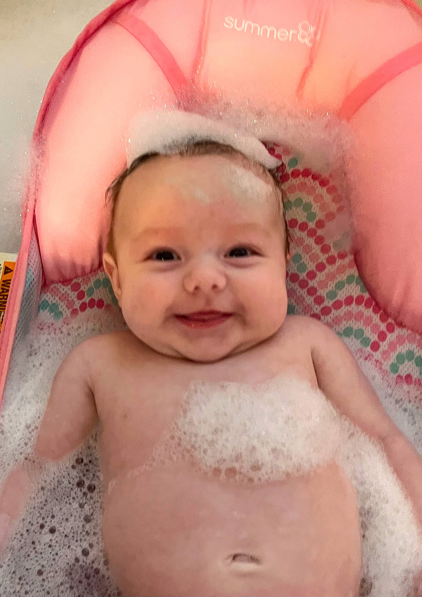 Gracie is registered to the contest to win money with this photo: baby, baby_bathing, bathing, cheek, chest, chin, eyebrow, eyelash, foam, happy, iris, joy, lip, mouth, nose, organ, person, pink, product, skin
