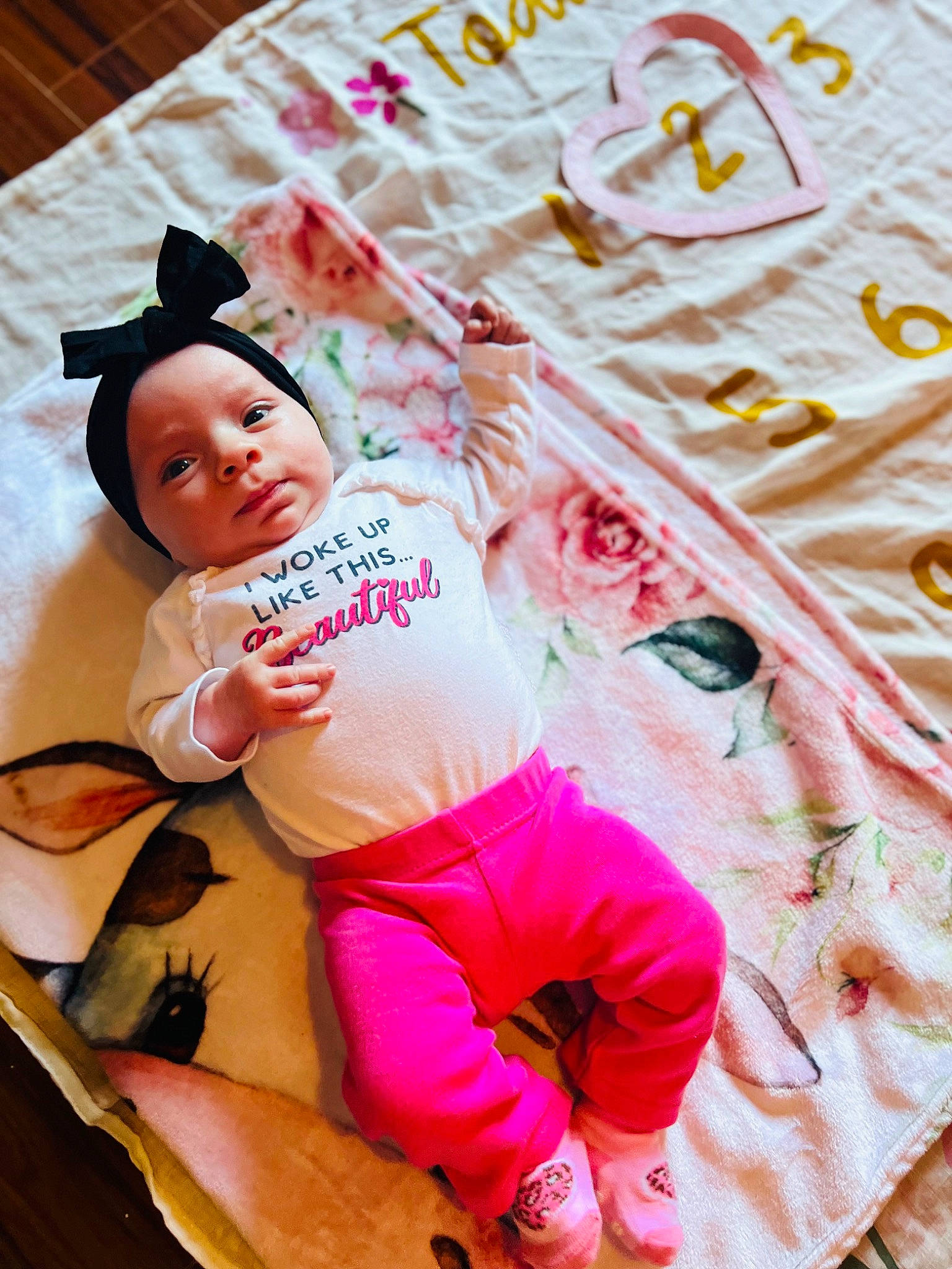 Oaklynn is registered to the contest to win money with this photo: abdomen, baby, baby_products, baby_toddler_clothing, bedding, child, comfort, fun, happy, leisure, linens, magenta, pattern, person, pink, play, room, sitting, textile, thigh