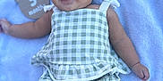 Abigail Ortuno is registered to the contest to win money with this photo: baby, infant, smiling, cute, outdoor, blanket, clothing, green_checkered, happy, face, child, person, pigtails, skin, legs, arms, mouth, eyes, head, toddler