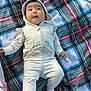 baby, infant, hoodie, blanket, plaid, outdoor, grass, clothing, cute, child, person, sock, portrait, sitting, expression, young, casual, warm, daylight, hand