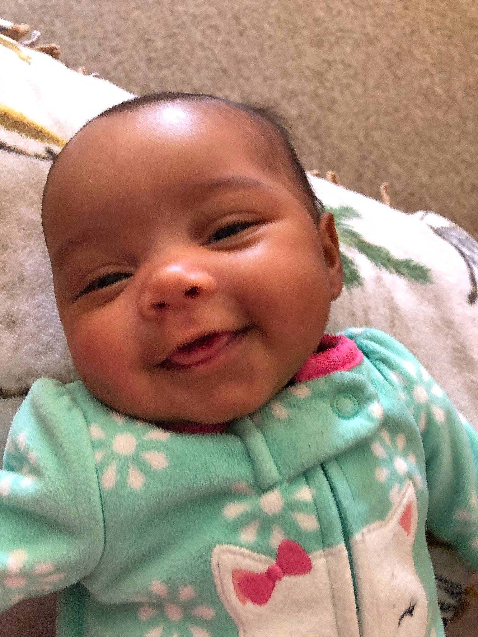 Gabriella is registered to the contest to win money with this photo: baby, baby_toddler_clothing, cheek, chin, eye, eyebrow, facial_expression, finger, forehead, hairstyle, happy, iris, leaf, lip, mouth, nose, person, pink, skin, sleeve